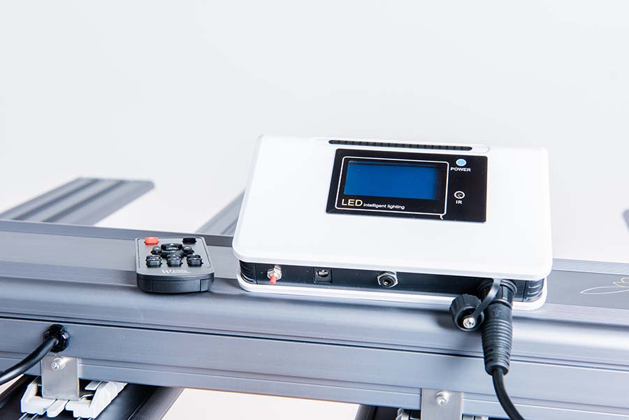 white environment controller sitting on l.e.d. light